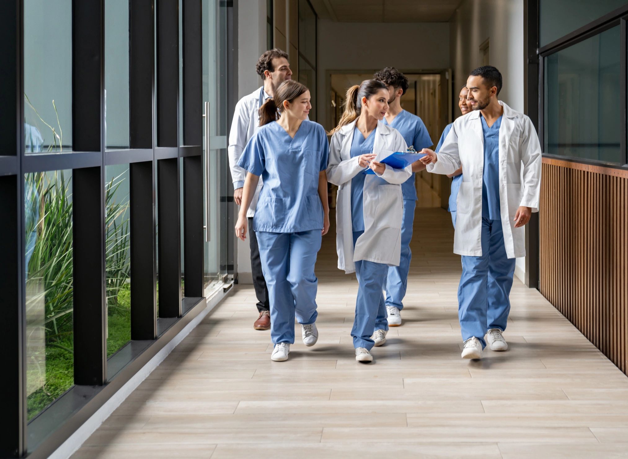 Diverse healthcare team walking hospital corridor